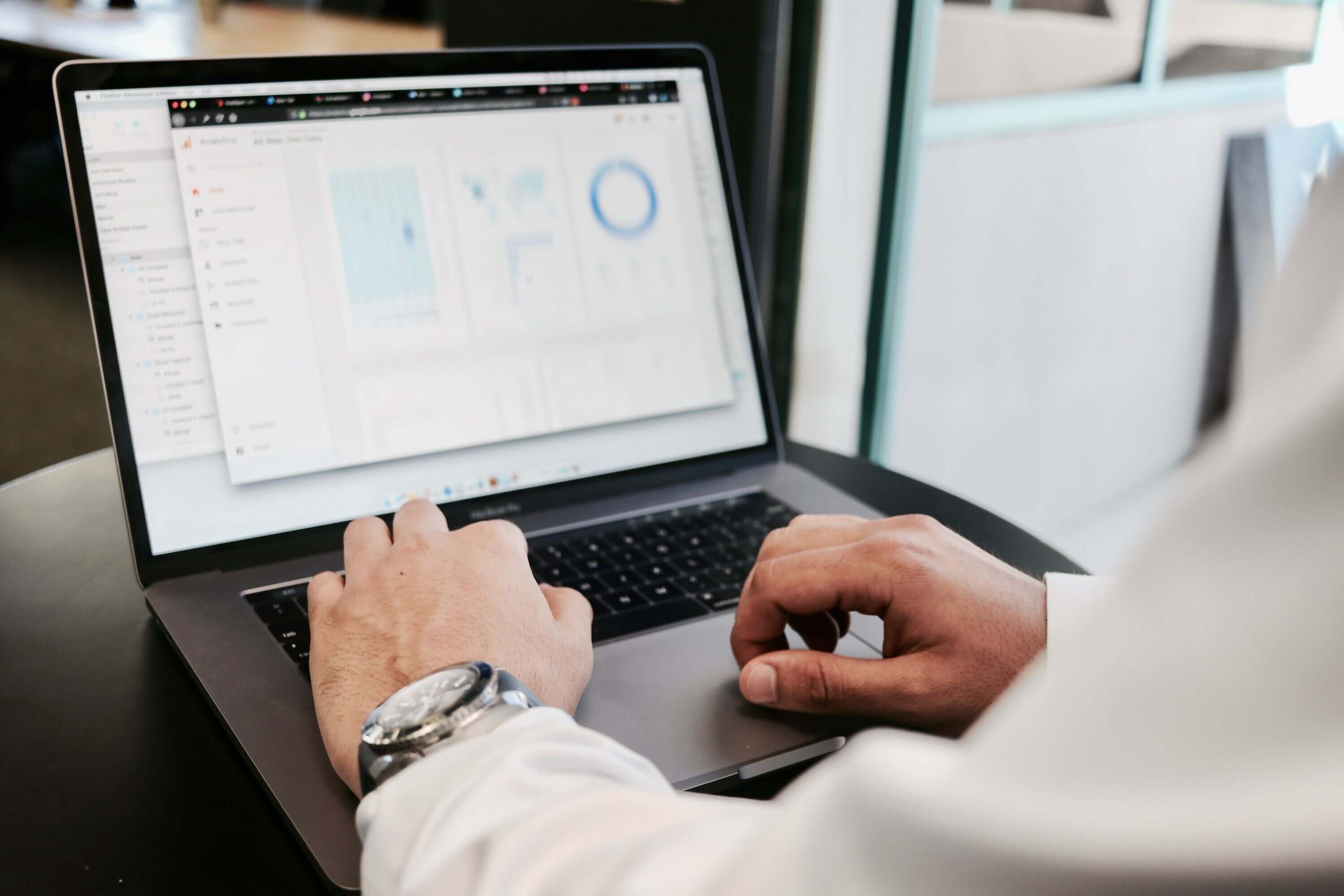 man looking at analytics on laptop